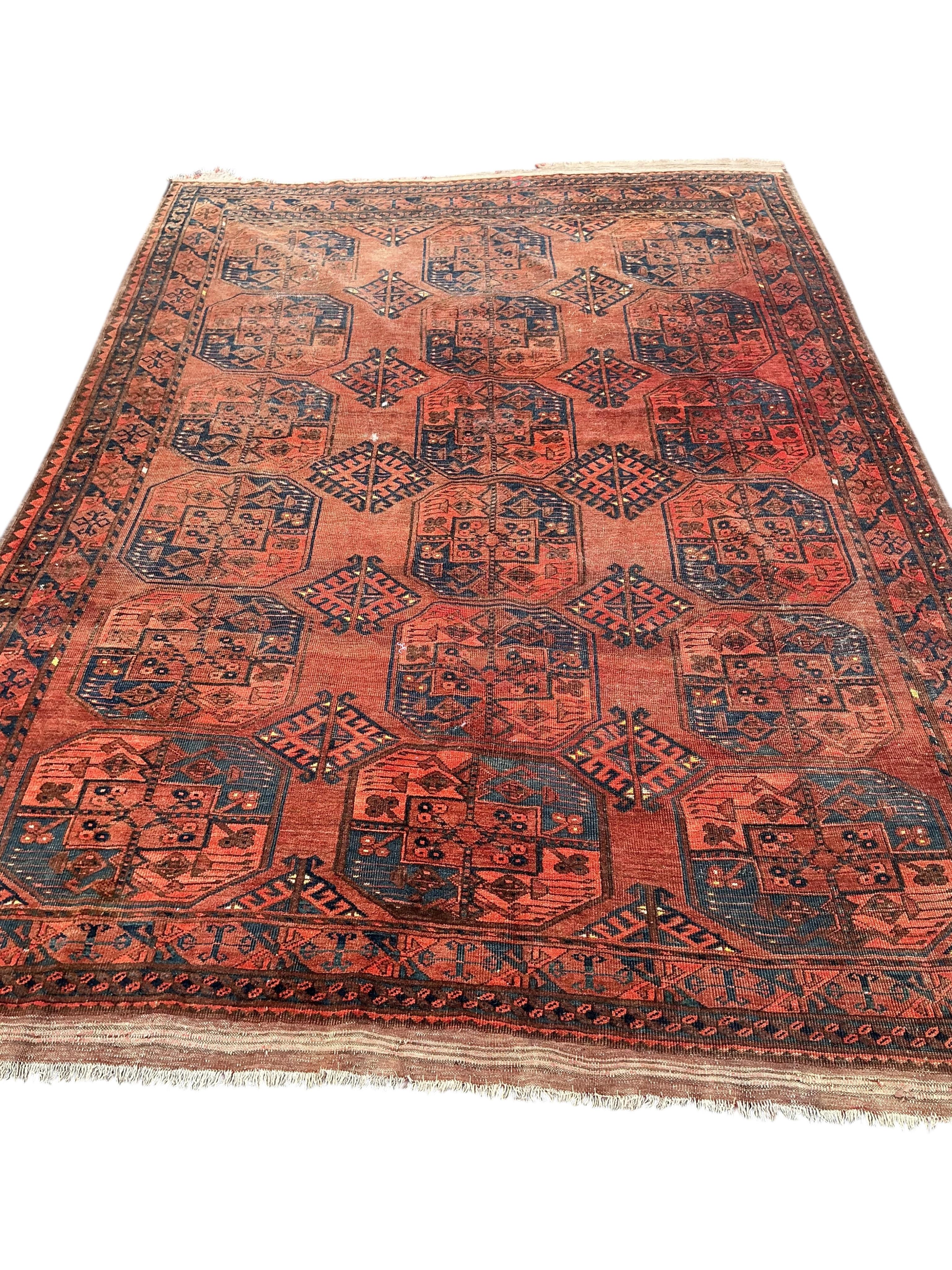 An Afghan brick red ground carpet, 285 x 210cm